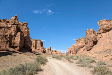 Views within the Charyn Canyon to the reddish sandstone cliffs. The canyon is also called valley of...