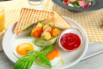 Club sandwich panini with ham, tomato, cheese and basil with cheese balls