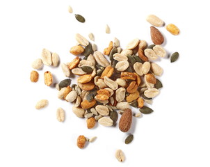 Healthy food mix of salted and spicy peanuts, sunflower and pumpkin seeds, almonds isolated on white background, top view