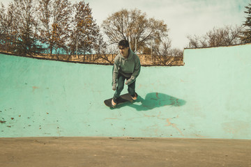 Guy practicing skateboarding and doing tricks in a skatepark