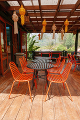 Orange outdoor table & chairs in bistro café in daytime for relaxation, travel, season, time, holiday, gastronomy, concept
