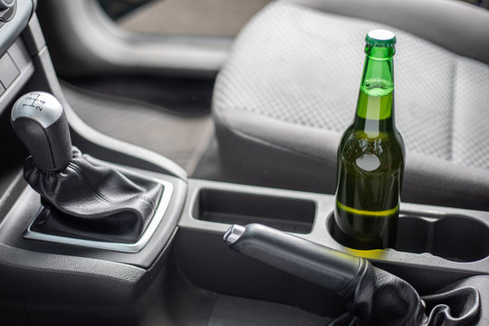 Drink and drive. Bottle of beer inside the car. Don't Drink for Drive