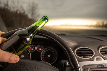 Drink and drive. Driver holding beer and driving wheel. Don't Drink for Drive