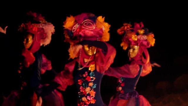 The face of the girl at the masquerade in a Venetian suit hides a mysterious mask. Dance with fire in the night. Concept idea for dance