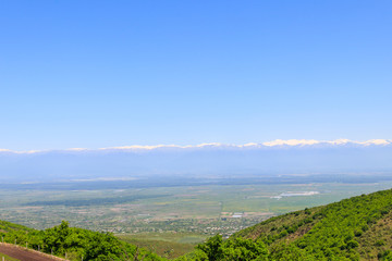 Fototapeta premium View on Alazani valley and Caucasus mountains from Sighnaghi, Kakheti, Georgia