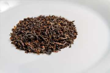 Black tea leaves on a white background