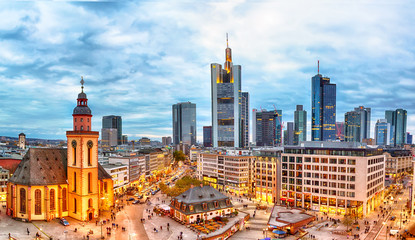 Frankfurt, Germany - November, 2018: View to skyline of Frankfurt during sunset. St. Catherine's Church and the Hauptwache Main Guard building with famous Frankfurt skyscrapers. - obrazy, fototapety, plakaty
