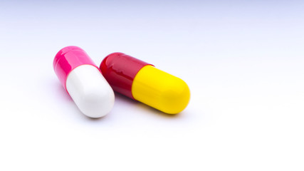 Medicine pills or capsules closeup on a white background with selective focus and crop fragment