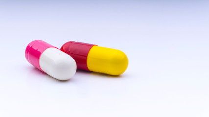Medicine pills or capsules closeup on a white background with selective focus and crop fragment