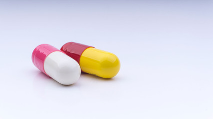 Medicine pills or capsules closeup on a white background with selective focus and crop fragment