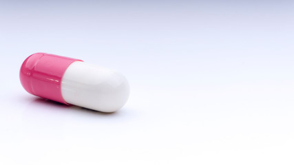 Medicine pills or capsules closeup on a white background with selective focus and crop fragment