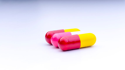 Medicine pills or capsules closeup on a white background with selective focus and crop fragment