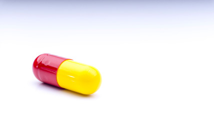 Medicine pills or capsules closeup on a white background with selective focus and crop fragment