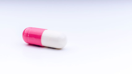 Medicine pills or capsules closeup on a white background with selective focus and crop fragment