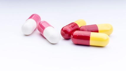 Medicine pills or capsules closeup on a white background with selective focus and crop fragment