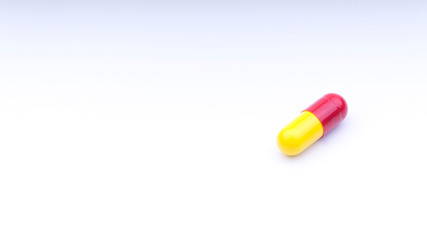 Medicine pills or capsules closeup on a white background with selective focus and crop fragment