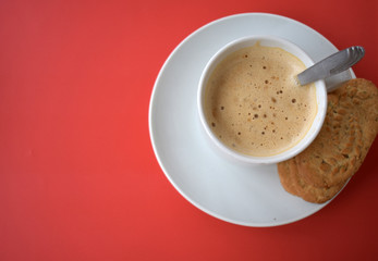 Cup of coffee on a red background.