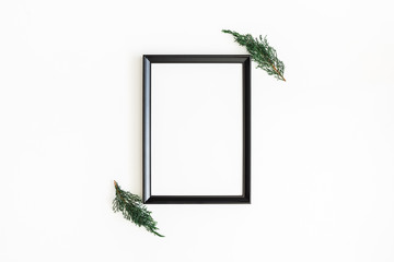 Christmas composition. Photo frame, fir tree branches on white background. Christmas, winter, new year concept. Flat lay, top view, copy space