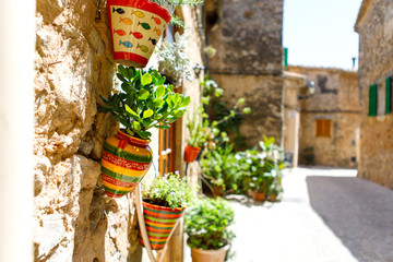 Beautiful street in Valldemossa with traditional flower decoration, famous old mediterranean village of Majorca. Balearic island Mallorca, Spain