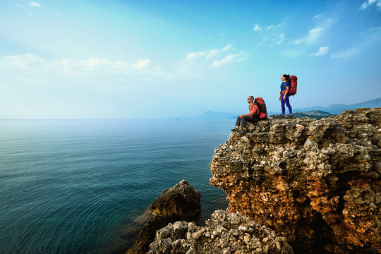 Adventure trek along the coast with a backpack in the summer. - Powered by Adobe