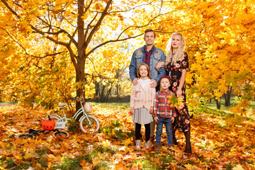 Image of parents and children on walk in autumn park