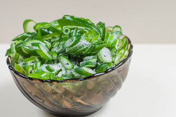 green onions frozen on a  platter on a white background