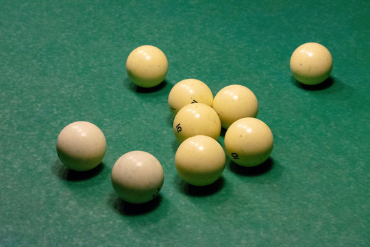 Billiard balls on a green pool table.