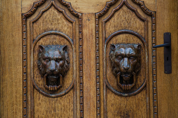 Carved wooden antique doors with lion heads