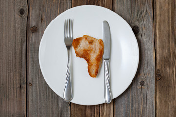 slice of roasted meat in the shape of a continent Africa