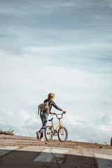 Fototapeta na wymiar Portrait of a boy on a bicycle in park outdoors