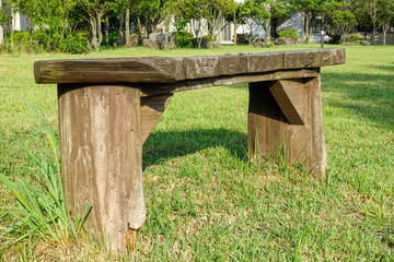 empty wooden bench on the grass