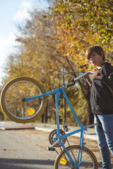 Obraz premium Portrait of a boy on a bicycle in park outdoors