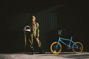 Portrait of a boy on a bicycle in street astronaut dress