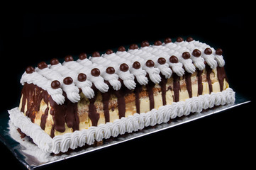 long cake on black background