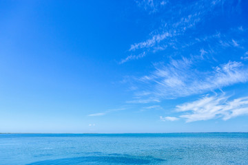 Obraz premium Beautiful blue sea water & vibrant sky with fluffy white clouds in summer.Beauty of nature for background design