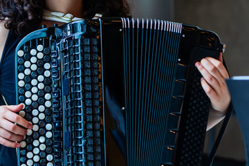 Close-up musician playing the accordion on the stage
