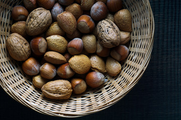 close-up of nuts, hazelnuts and almonds in a basket