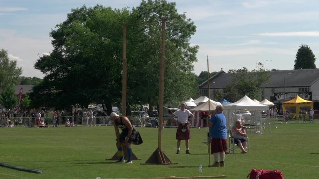 Throwing a heavy weight over a high bar