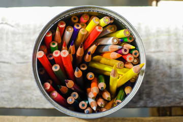 directly above shot of color pencils on the wooden table