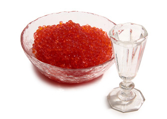 Fish caviar and glass of vodka on white background