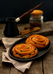 Homemade cinnamon and raisin buns and freshly brewed coffee