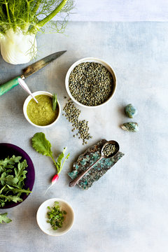 Green Lentil Salad Ingredients. Photographed on a light blue background.