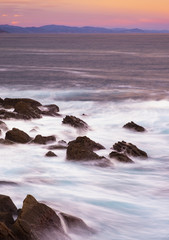 The waves of the sea hit rocks on the Euskadi coast