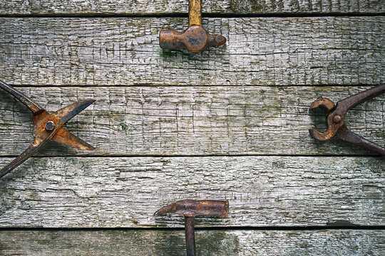 Vintage rusty hand working tools on the rough wooden boards. Copy space. Flat lay. Fathers day concept.