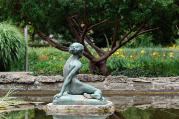 Beautiful old sculpture in park. Japanese Garde in Margaret Island - Budapest, Hungary