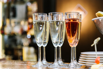 Glasses with champagne are on the bar