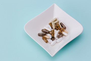 various tablets and capsules for treatment of the disease on a plate