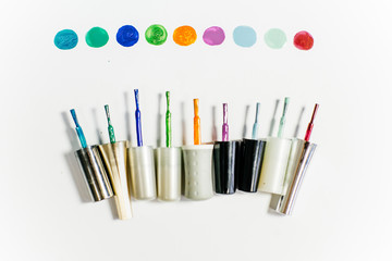 several paintbrushes with paint on a table