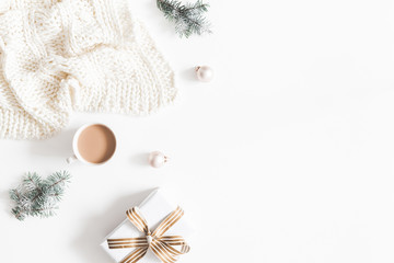 Christmas composition. Gift, fir tree branches, plaid, cup of coffee, balls on white background. Christmas, winter, new year concept. Flat lay, top view, copy space
