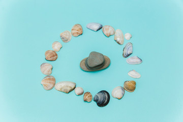 Seashells and stones, souvenirs brought from vacation on a blue background